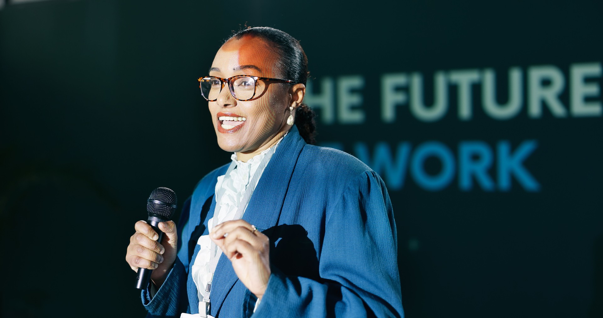 Black woman, mic and speech at conference for public speaking, presentation and international convention. Presenter, talking and seminar on stage for audience, motivation and global event with pitch